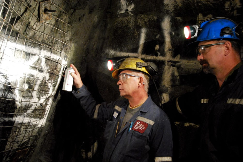 Two male miners inside a mine