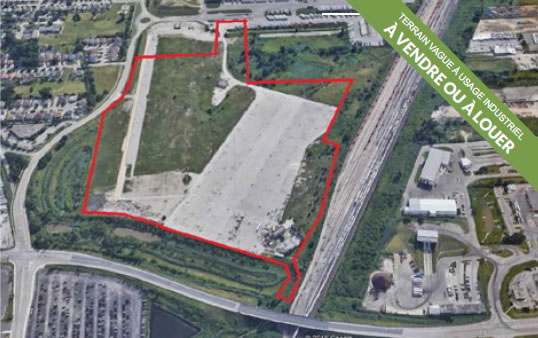 Photographie vue aérienne du terrain industriel vacant / à vendre au 3911 Plymouth Drive, Windsor, Ontario, Canada.