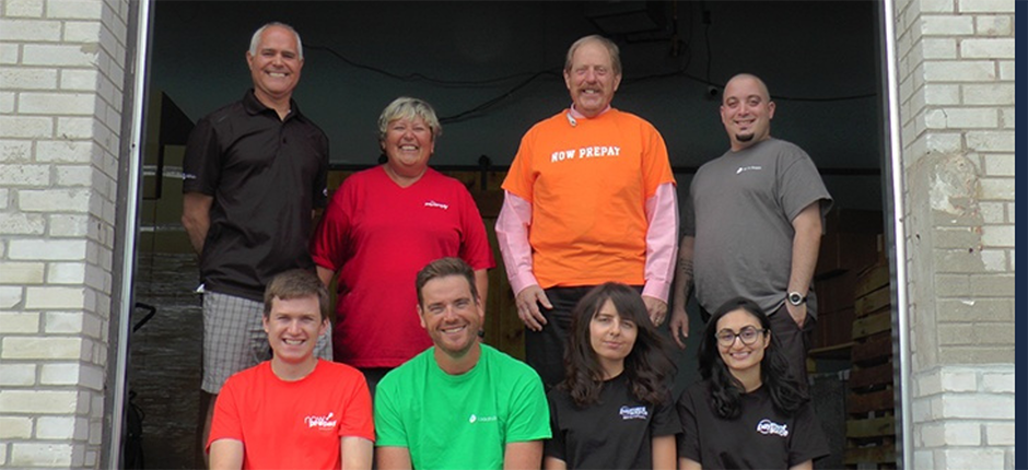 Smiling Payment Source employees wearing different coloured t-shirts