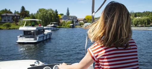 A customer driving a Le Boat yacht, cruising its Ontario waterways.