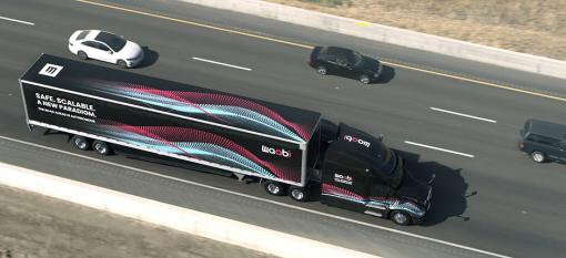 An electric truck travels along a highway